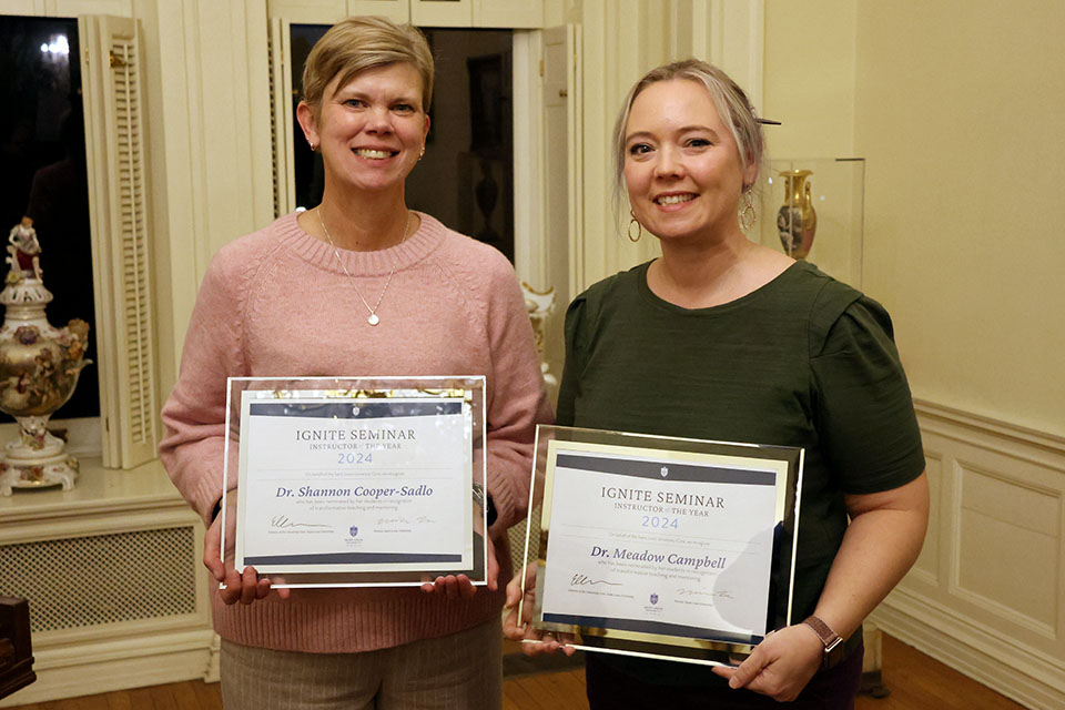 Shannon Cooper-Sadlo, Ph.D. (Social Work), left, and Meadow Campbell, Ph.D. (Center for Anatomical Science and Education) were honored at the reception on Tuesday, Dec. 3, for their work in teaching Ignite seminars. Photo by Joe Barker. 