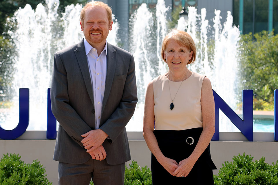 Max Zubatsky, Ph.D., left, and Marla Berg-Weger, Ph.D., pose for a photo in front of SLU's fountain.