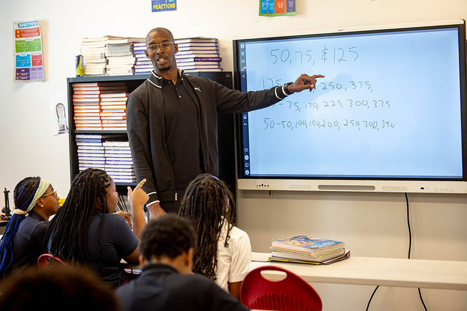 Math teacher Jamal Cooper leads a class at middle school students at St. Louis Catholic Academy on Sept. 16, 2024. Photo by Sarah Conroy.