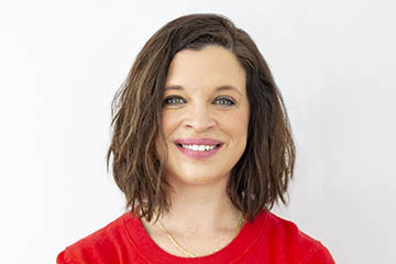 A cropped photo of Dr. Amy Wright. She poses for a photo in a long-sleeve red sweater against a white background.