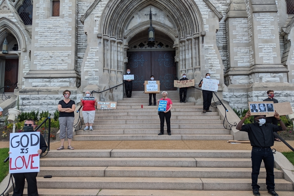 Jesuits, Jesuit Scholastics and members of the SLU community gather for a Tuesday Solidarity Stand on the steps of St. Francis Xavier College Church