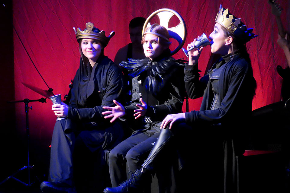 (From left) Sts. Margaret of Antioch (freshman Madelin Wysocky), Michael the Archangel (sophomore Spencer Lawton) and Catherine of Alexandria (freshman Grace Wallis) host their 'Live with the Saints' Talk Hour to learn more about Joan of Arc in a new Theatre and Dance Productions play.