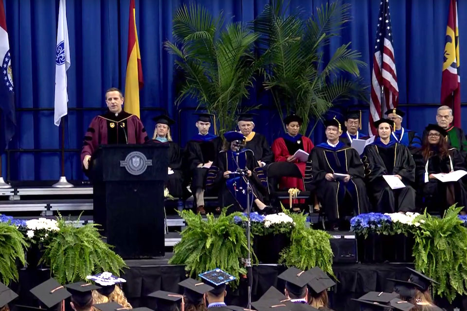 Fr. Chris Collins at the podium