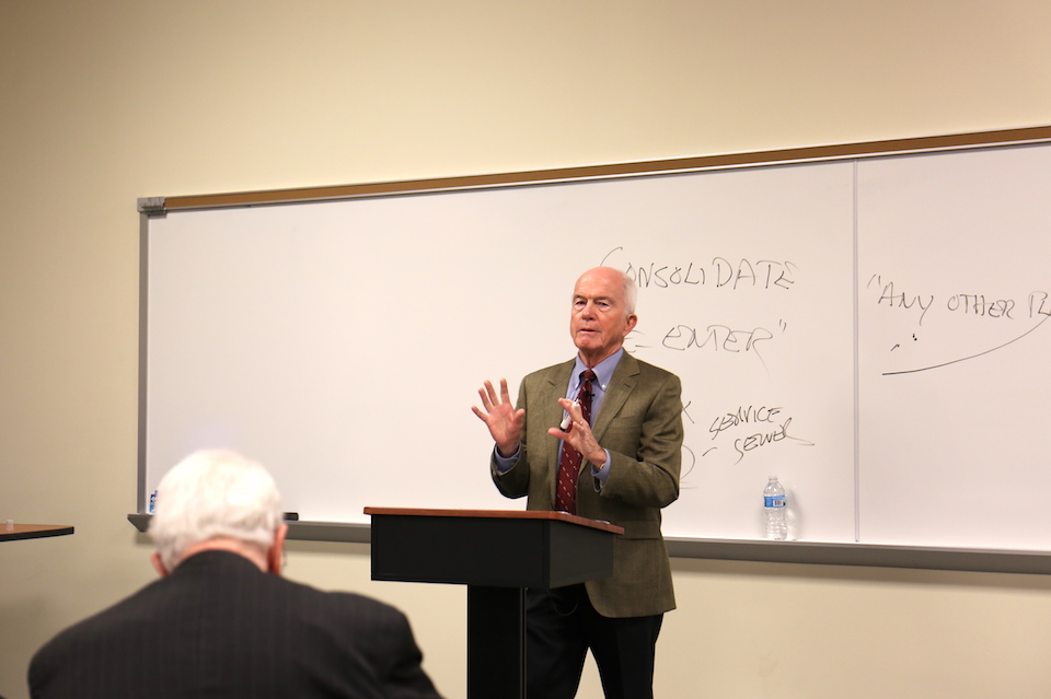 Roger Goldman, professor of law, stands in the front of the auditorium