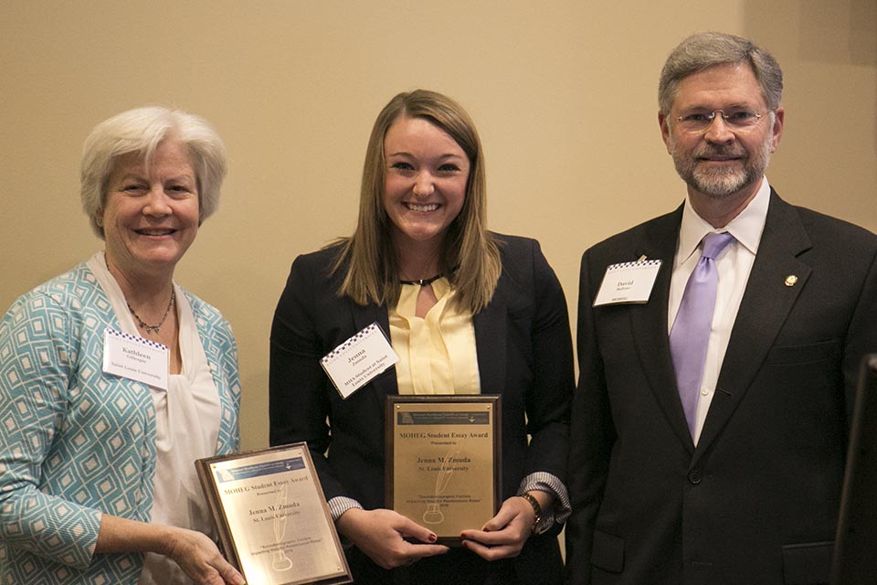 Kathleen Gillespie (left), interim chair for the health management and policy department holds a matching plaque. Jenna Zmuda stands center with her plaque. David Baltzer of the American College of Healthcare Executives is on the right. 