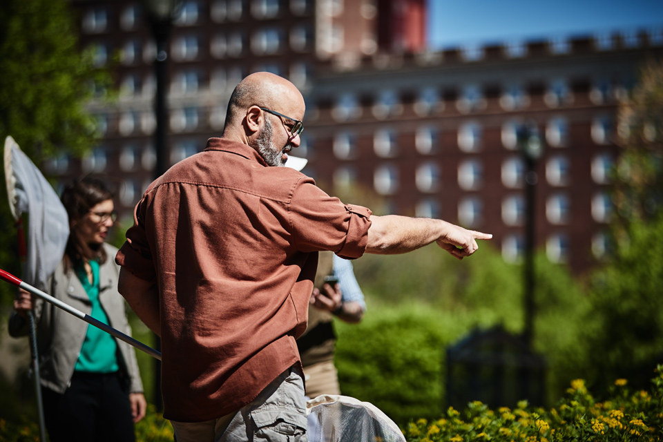 Camilo pointing out bees on campus