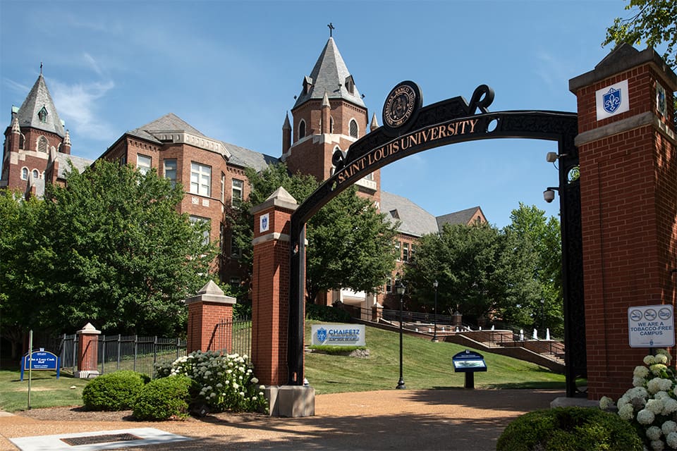 Cook Hall exterior with a Saint Louis University archway in the foreground